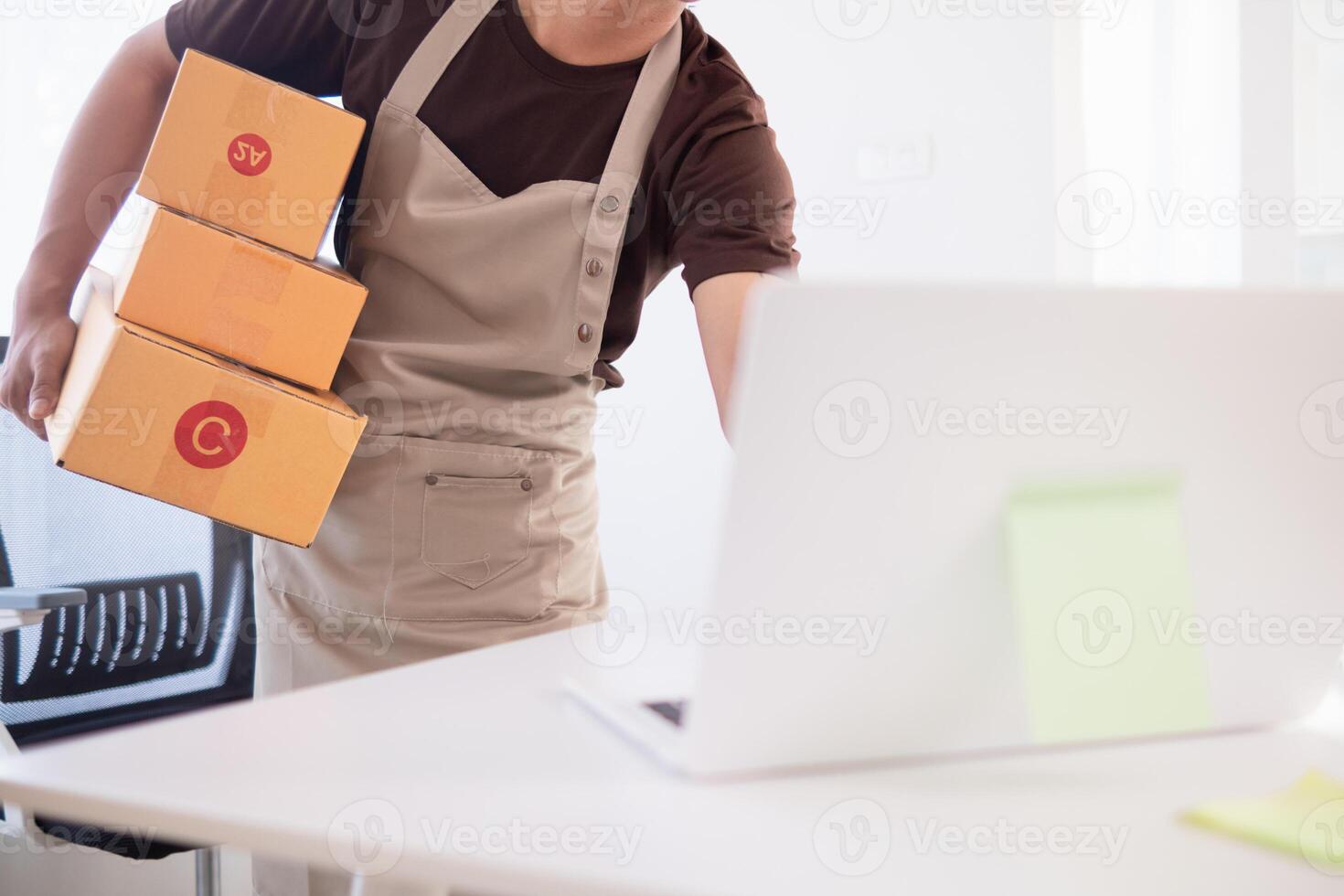 businessman decides invest in small SME business at home by using laptop and smartphone do online marketing and sell things online through an application before packing products according to orders. photo