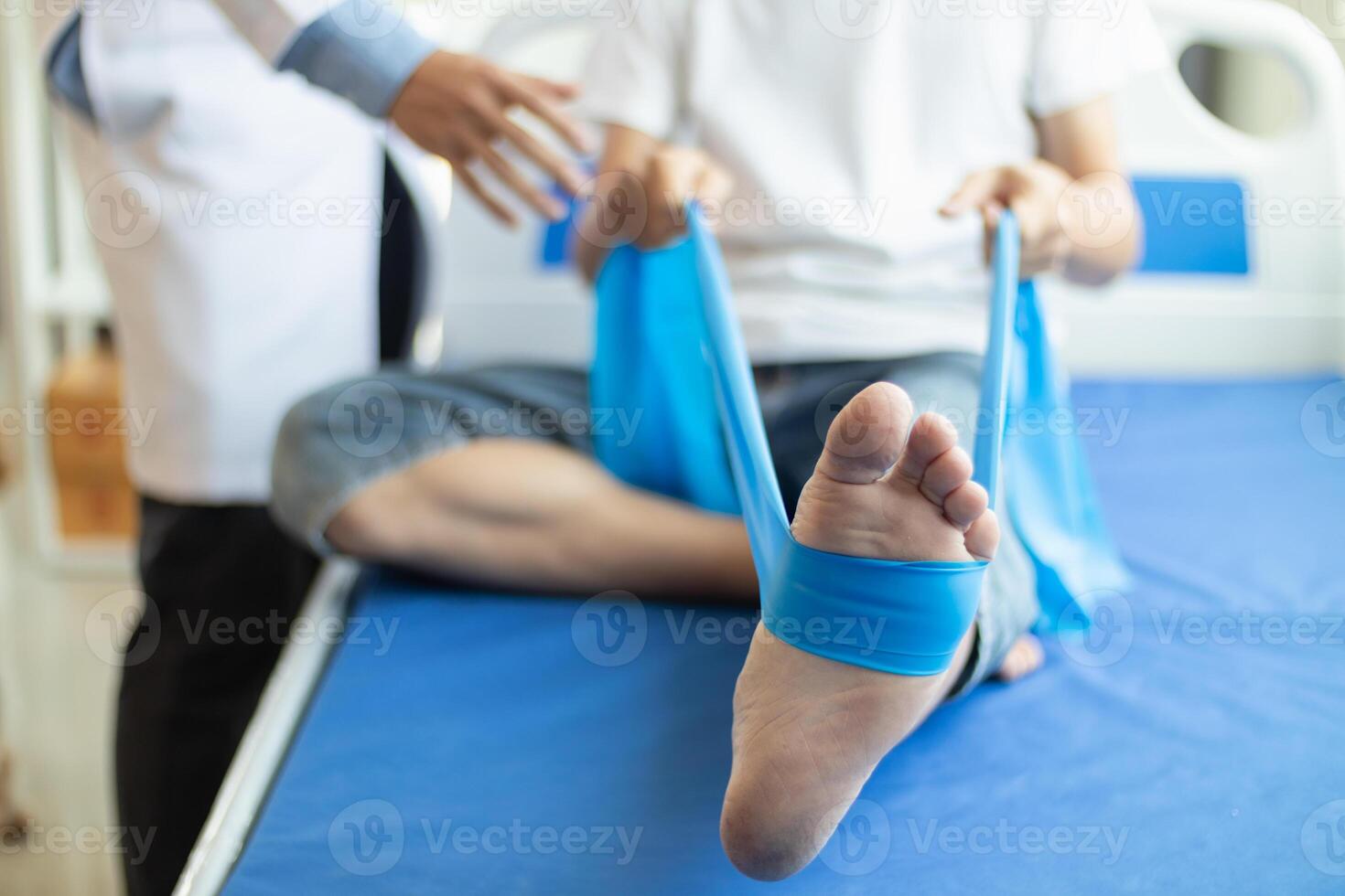 Doctors are examining patient muscle injuries and doing physical therapy for patient to move muscles so they can be used regularly because physical therapy will help strengthen muscles and blood flow. photo