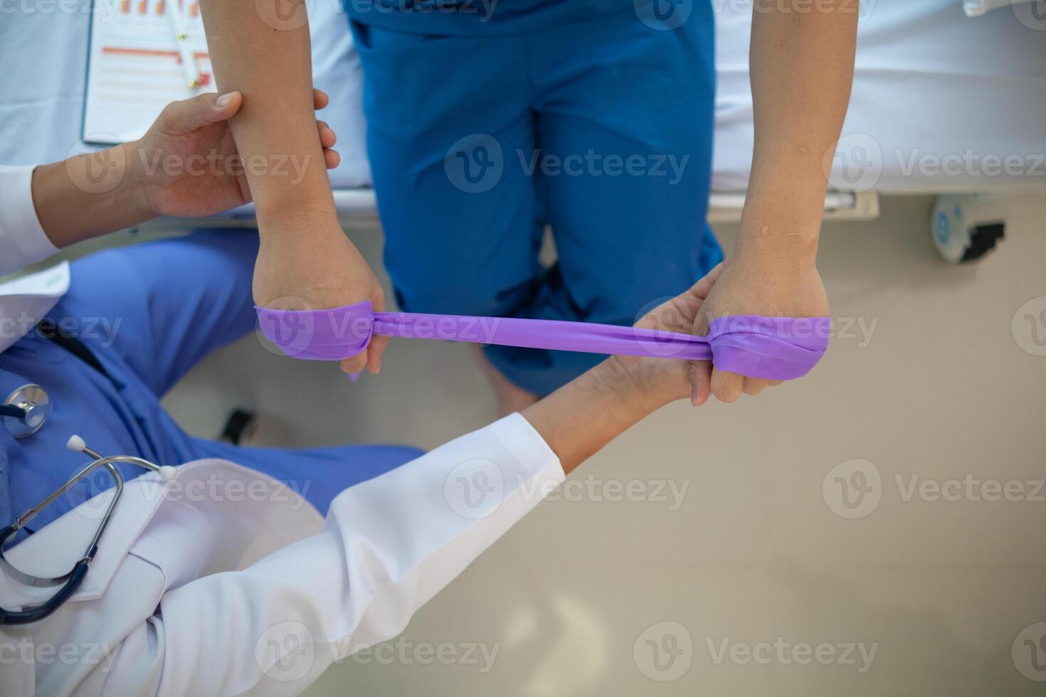 doctor is examining muscle injury and using elastic bands test injury and also help with physical therapy strengthen muscles because physical therapy will help strengthen muscles and help blood flow. photo