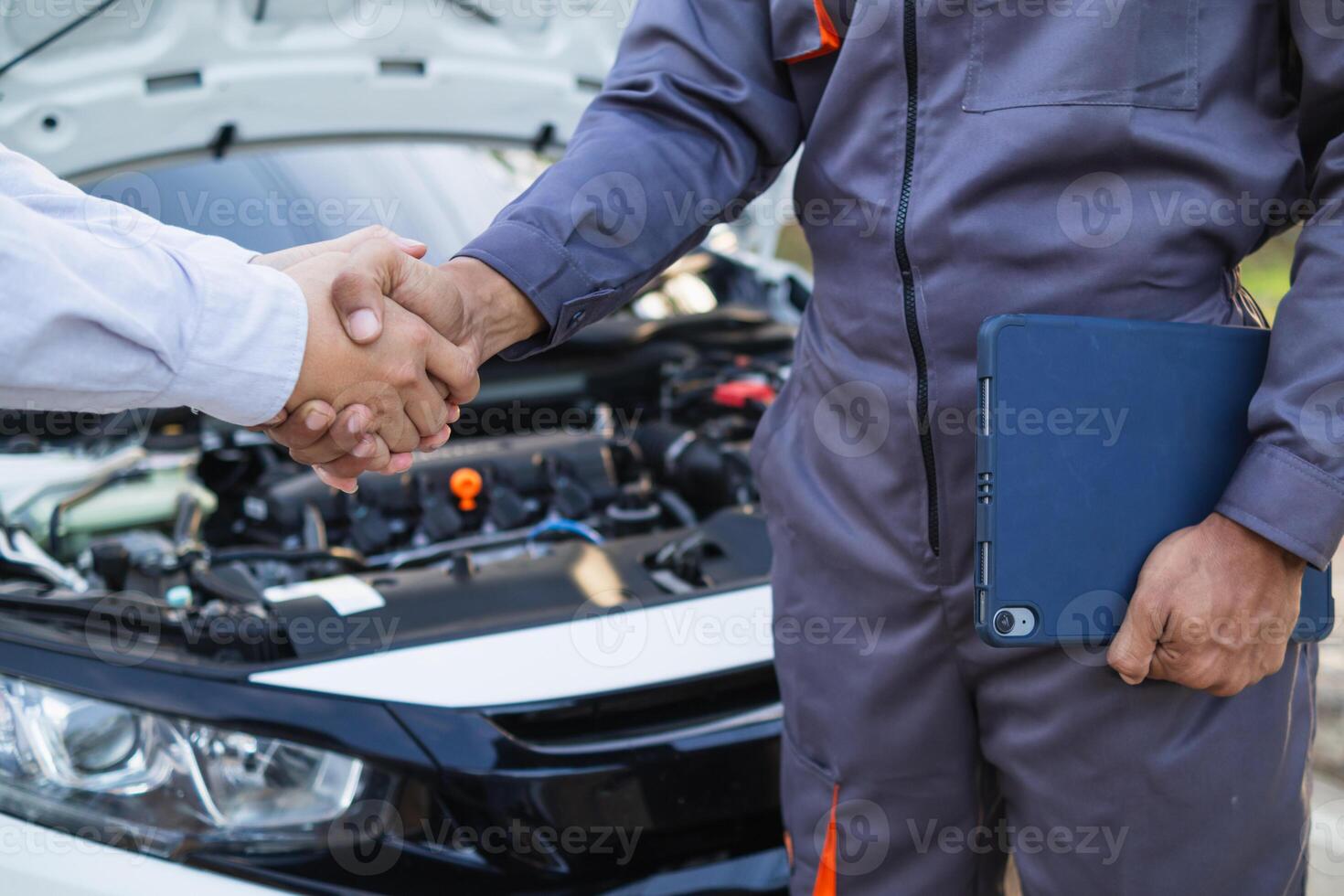 Technicians from service center inspect and assist customers cars that are having problems while traveling build confidence in customers who choose buy car from service center and receive help quickly photo