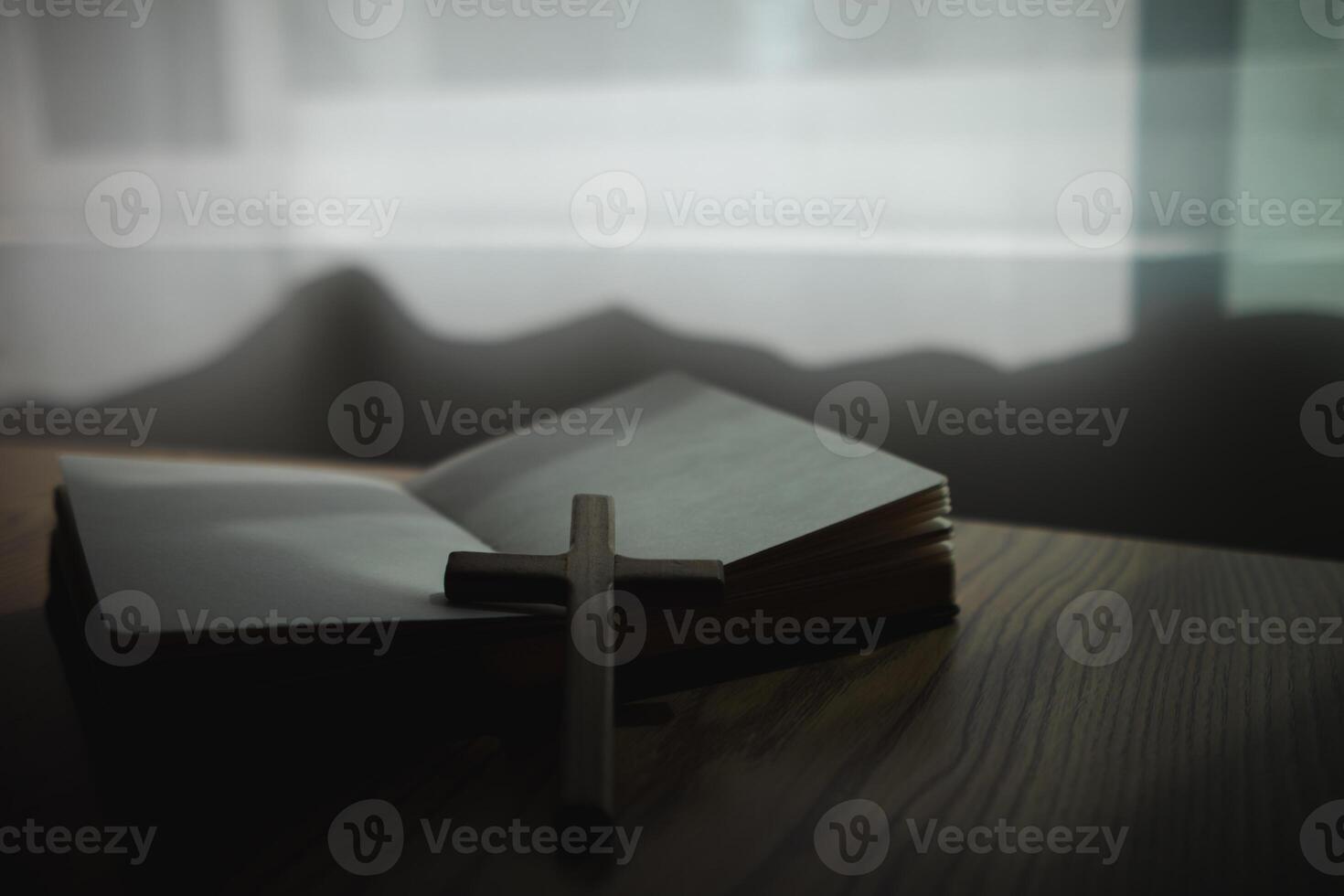 cross is placed on the Bible after prayer to God, which is religious ritual of Christianity and belief in the teachings of God. concept of praying to God with the teachings of the Bible and cross. photo