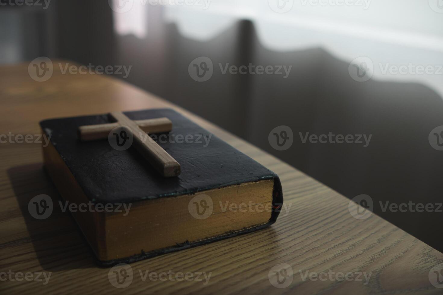 cross is placed on the Bible after prayer to God, which is religious ritual of Christianity and belief in the teachings of God. concept of praying to God with the teachings of the Bible and cross. photo