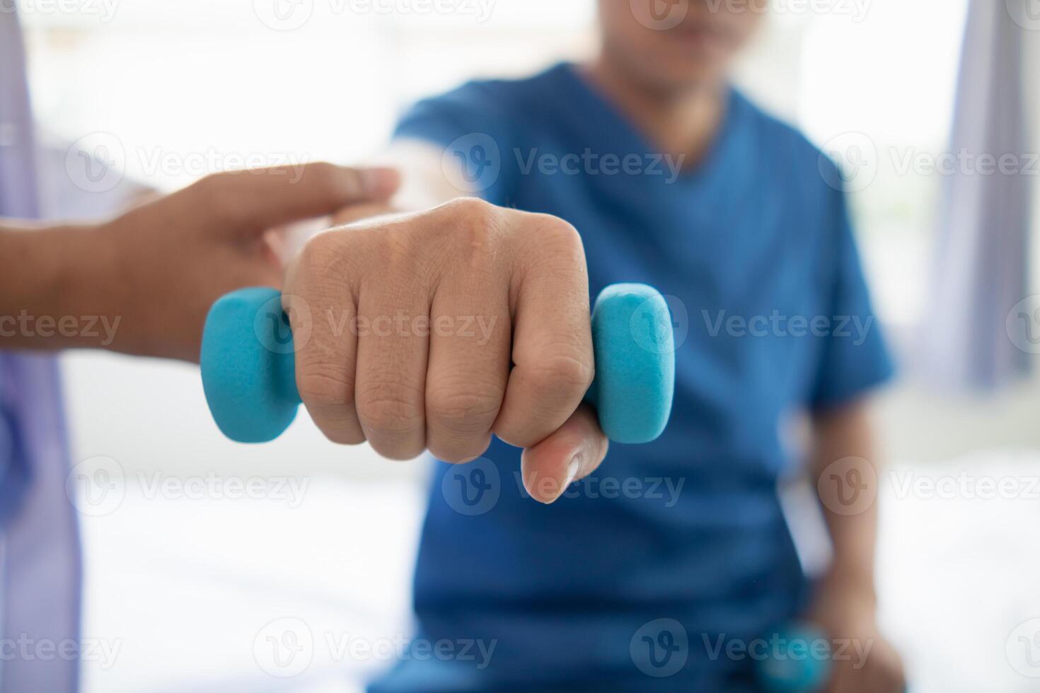 doctor is checking for muscle injuries and using dumbbells test injury and also help with physical therapy strengthen muscles because physical therapy will help strengthen muscles and help blood flow photo