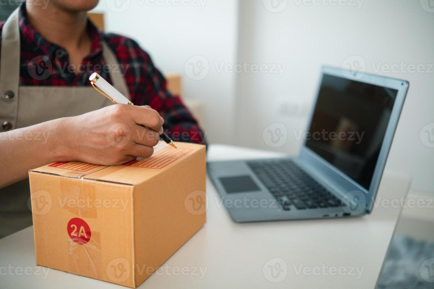 SME business operator is inspecting and packing products into parcel box for delivery company that will come pick up products after participating in online marketing with Application shopping online photo