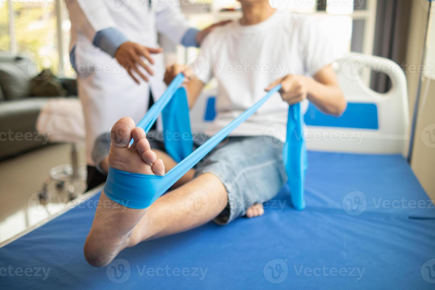 Doctors are examining patient muscle injuries and doing physical therapy for patient to move muscles so they can be used regularly because physical therapy will help strengthen muscles and blood flow. photo