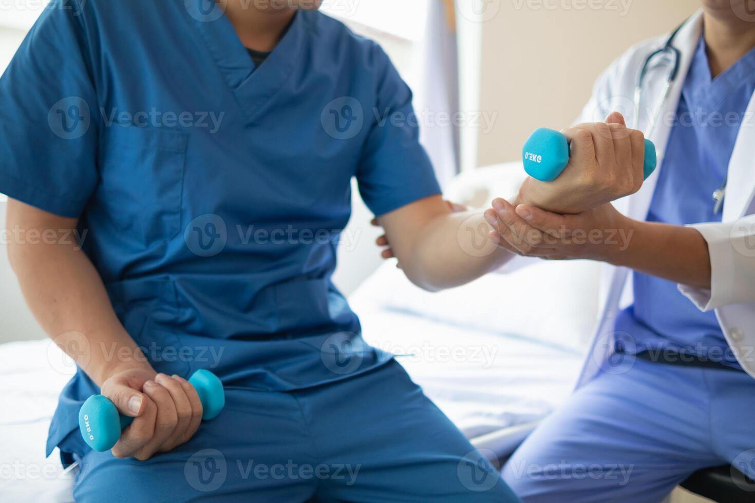 doctor is checking for muscle injuries and using dumbbells test injury and also help with physical therapy strengthen muscles because physical therapy will help strengthen muscles and help blood flow photo
