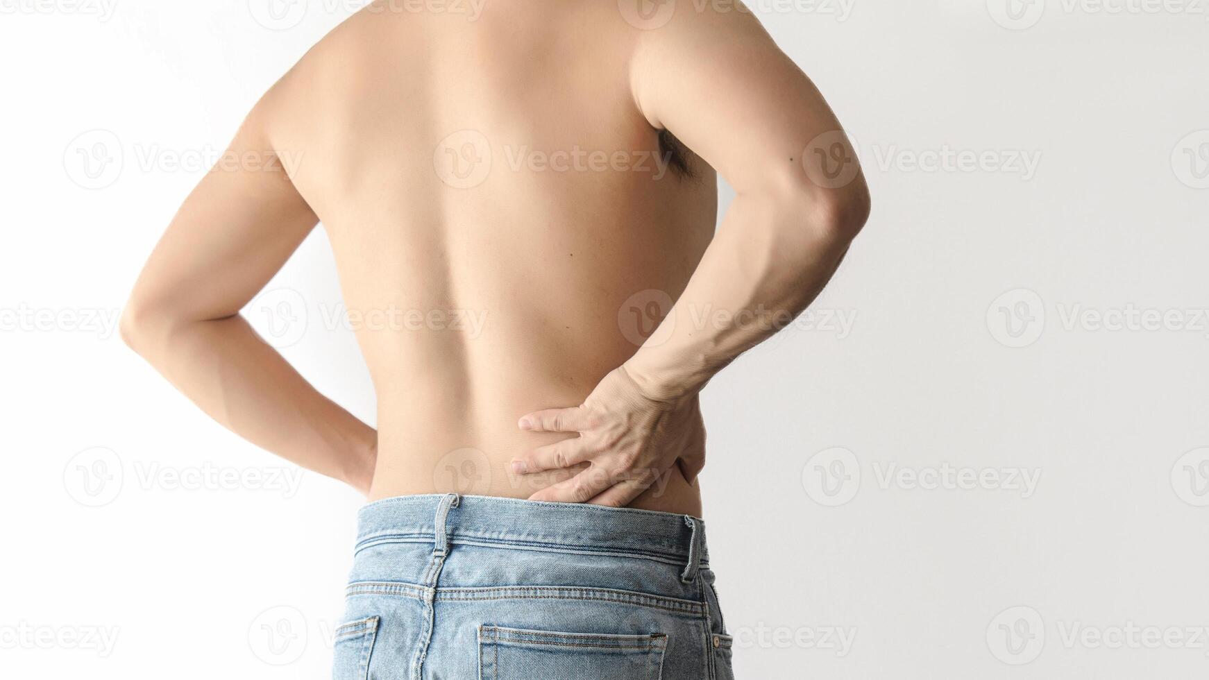 Shirtless man suffering from waist and back pain, with a white background and space for text photo