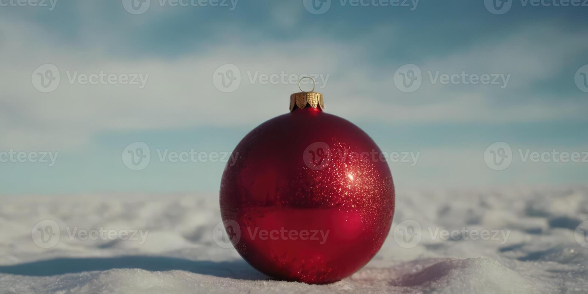 Christmas toy lying in the snow. The red toy glares in the morning light. photo