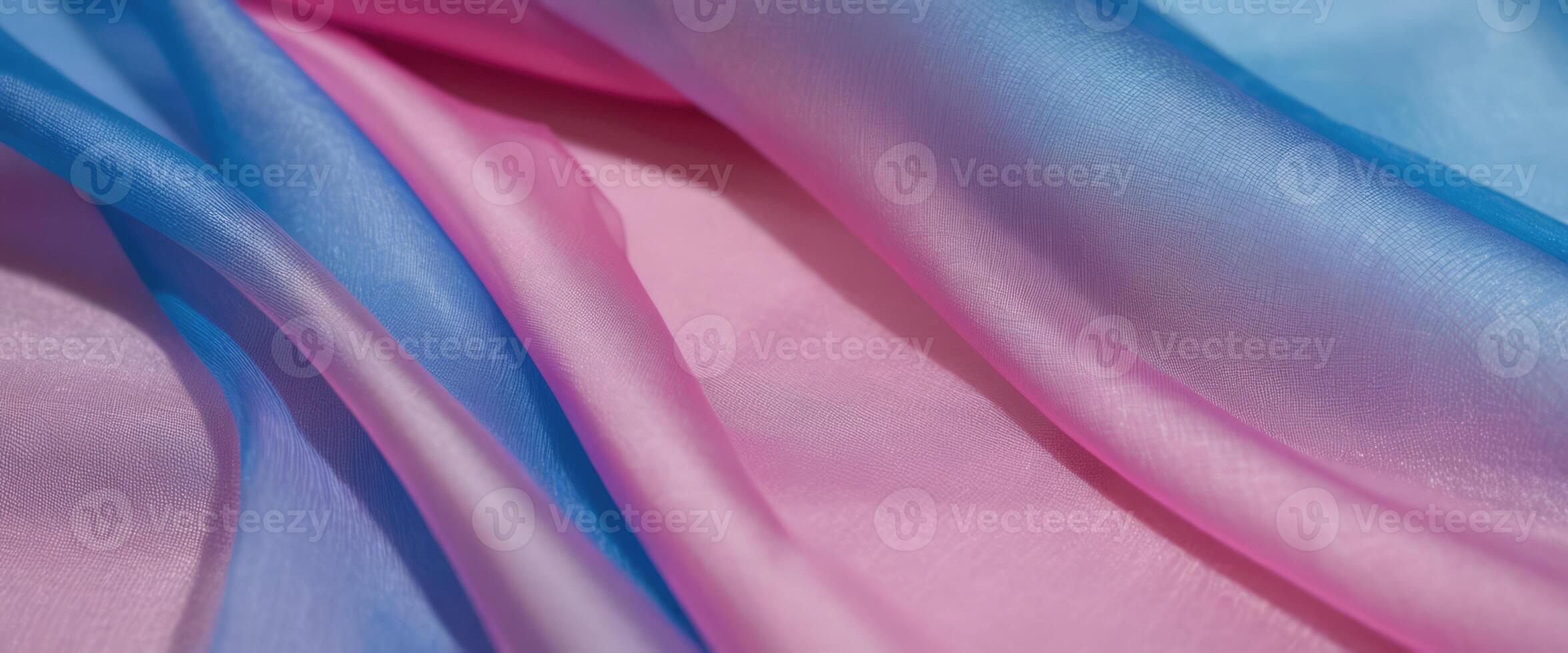 The thin pink and blue fabric sags in folds under its own weight photo