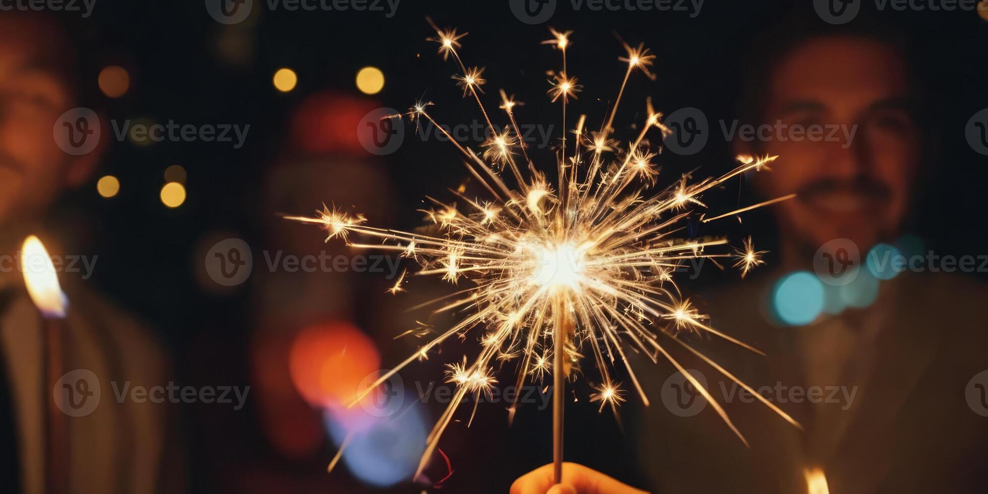 People holding a lit Sparkler. The soft light illuminates them. A warm New Year's atmosphere in the dark. photo