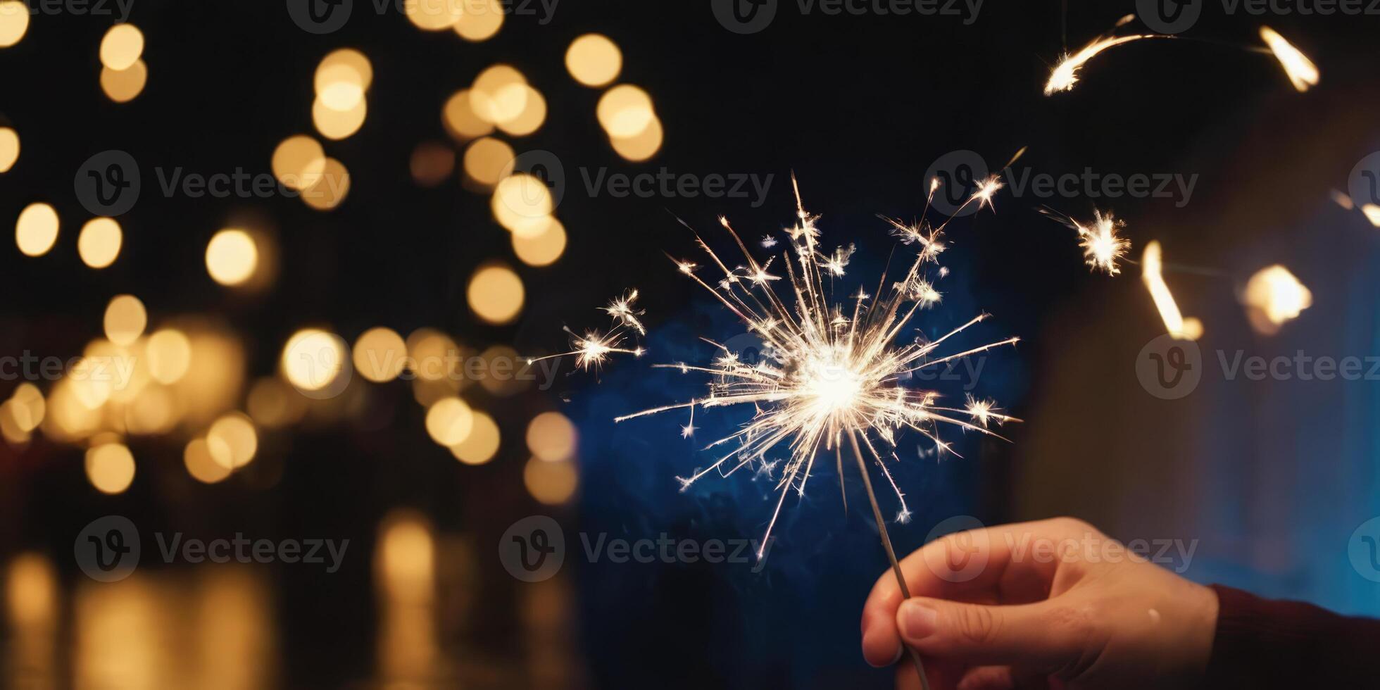 Sparkler glistens in the dark. A warm New Year's atmosphere in the dark. photo