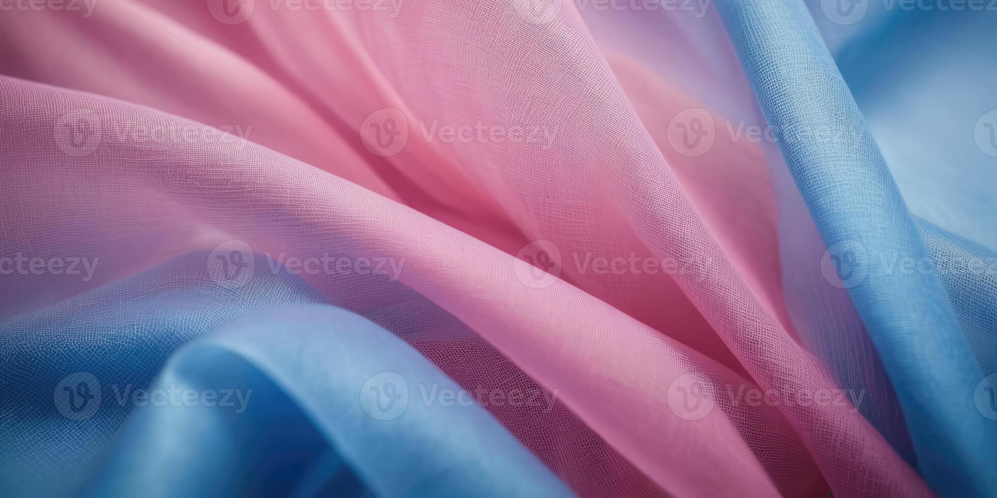 The thin pink and blue fabric sags in folds under its own weight photo