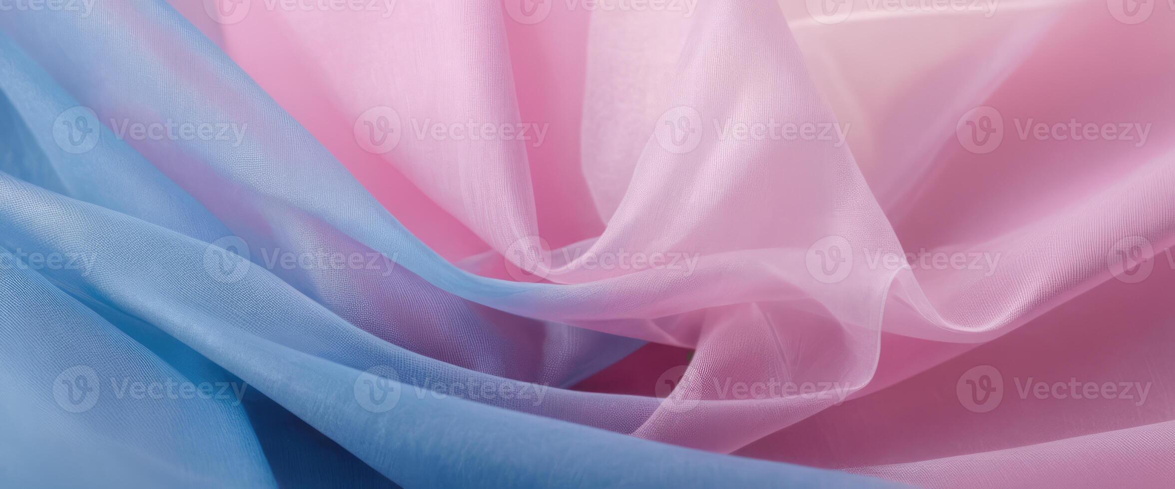 The thin pink and blue fabric sags in folds under its own weight photo