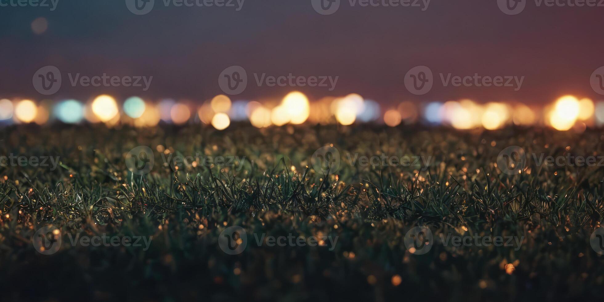 Artificial turf in the vicinity. The lights in the background are blurred. photo