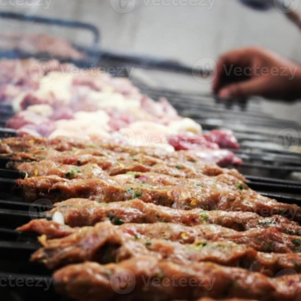 A kebab is a dish of vegetables, meat, or seafood cut into pieces, skewered, and cooked on a grill. photo
