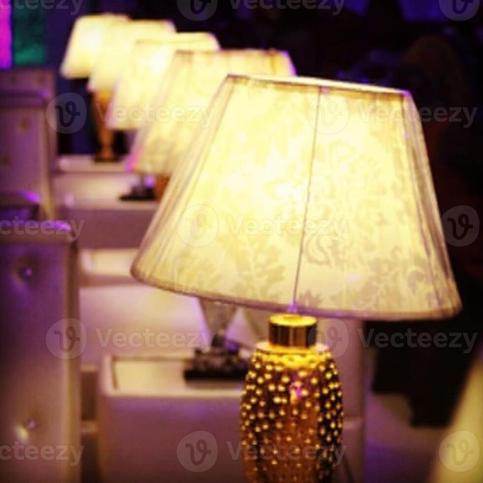 A lamp is a small appliance that holds an electric bulb and produces light. photo