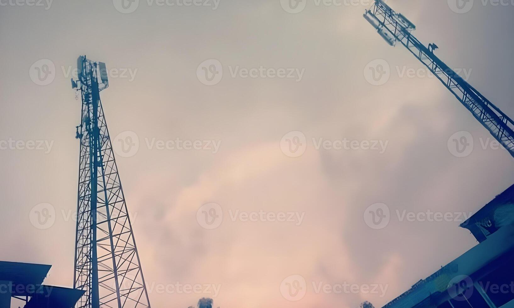 two cell phone towers in the sky with cloudy skies photo
