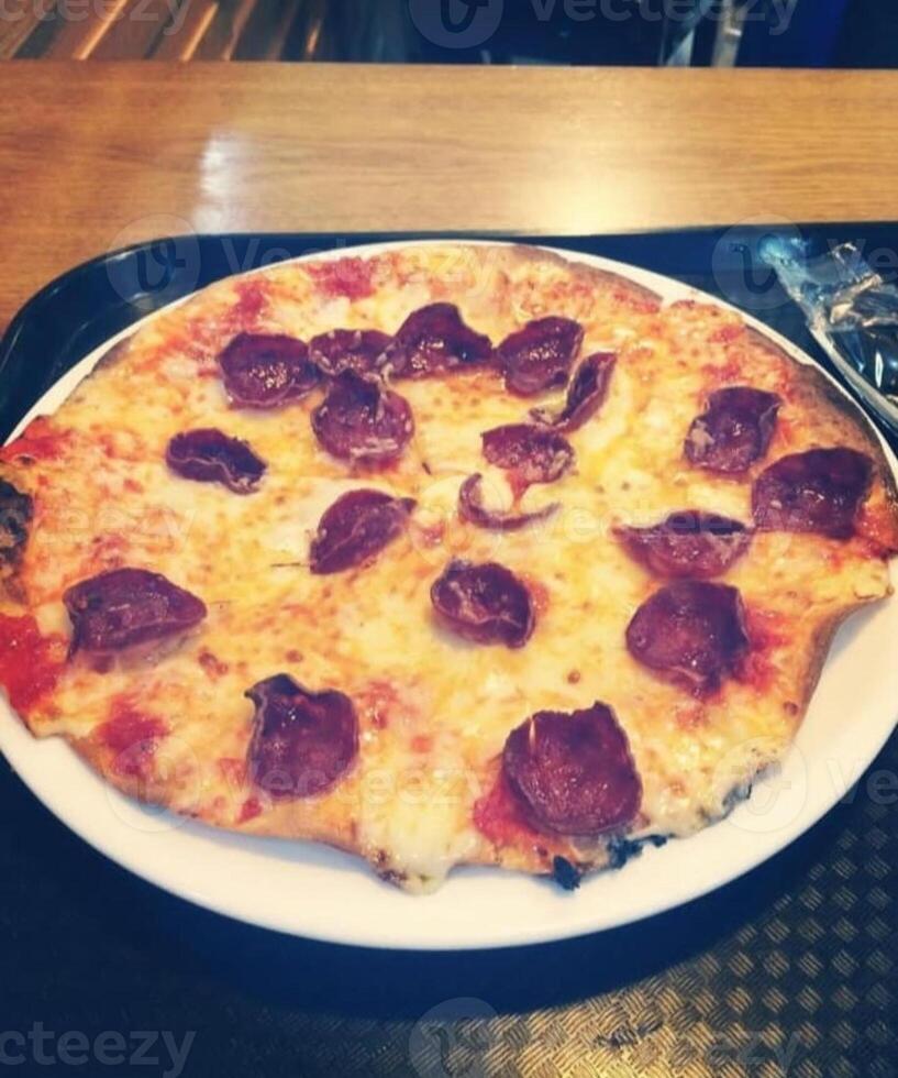 Pizza is an Italian food that was created in Italy The Naples area. It is made with different toppings. photo