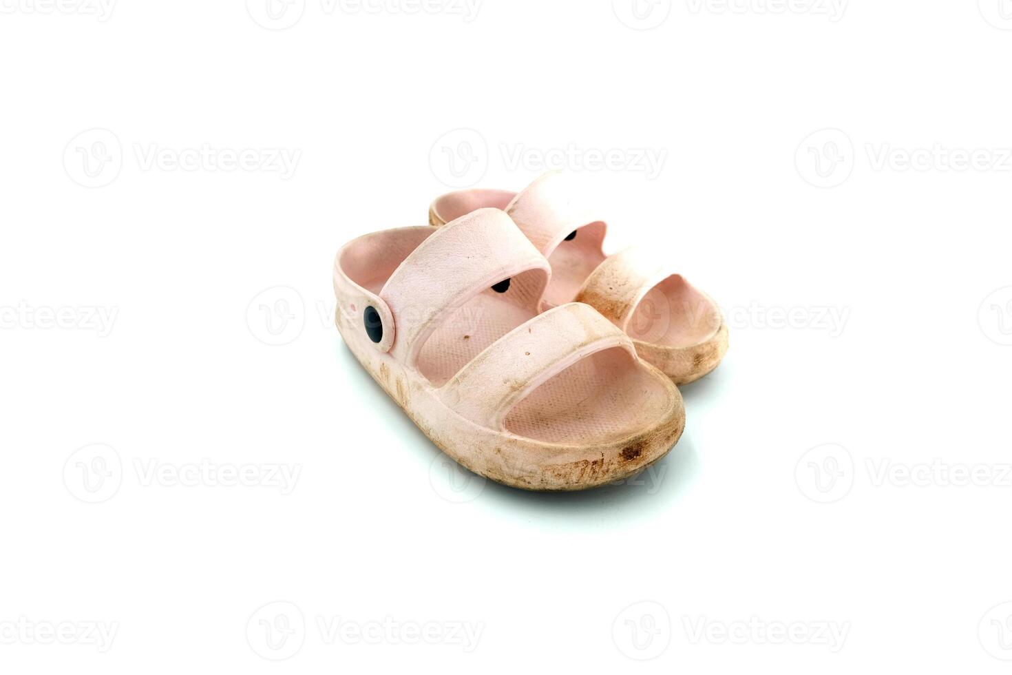 The girl's dirty pink slippers on a white background photo
