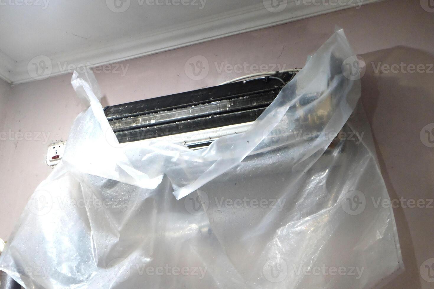 The AC unit is being cleaned photo