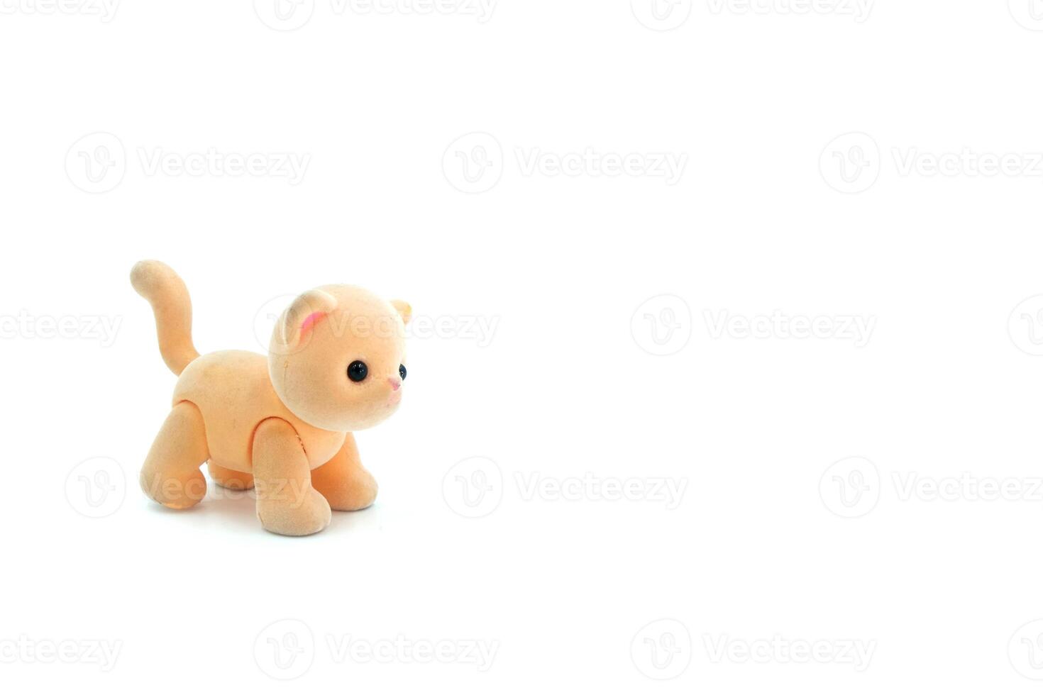 Close-up of a miniature toy cat on a white background. Copyspace can be used for your text. photo