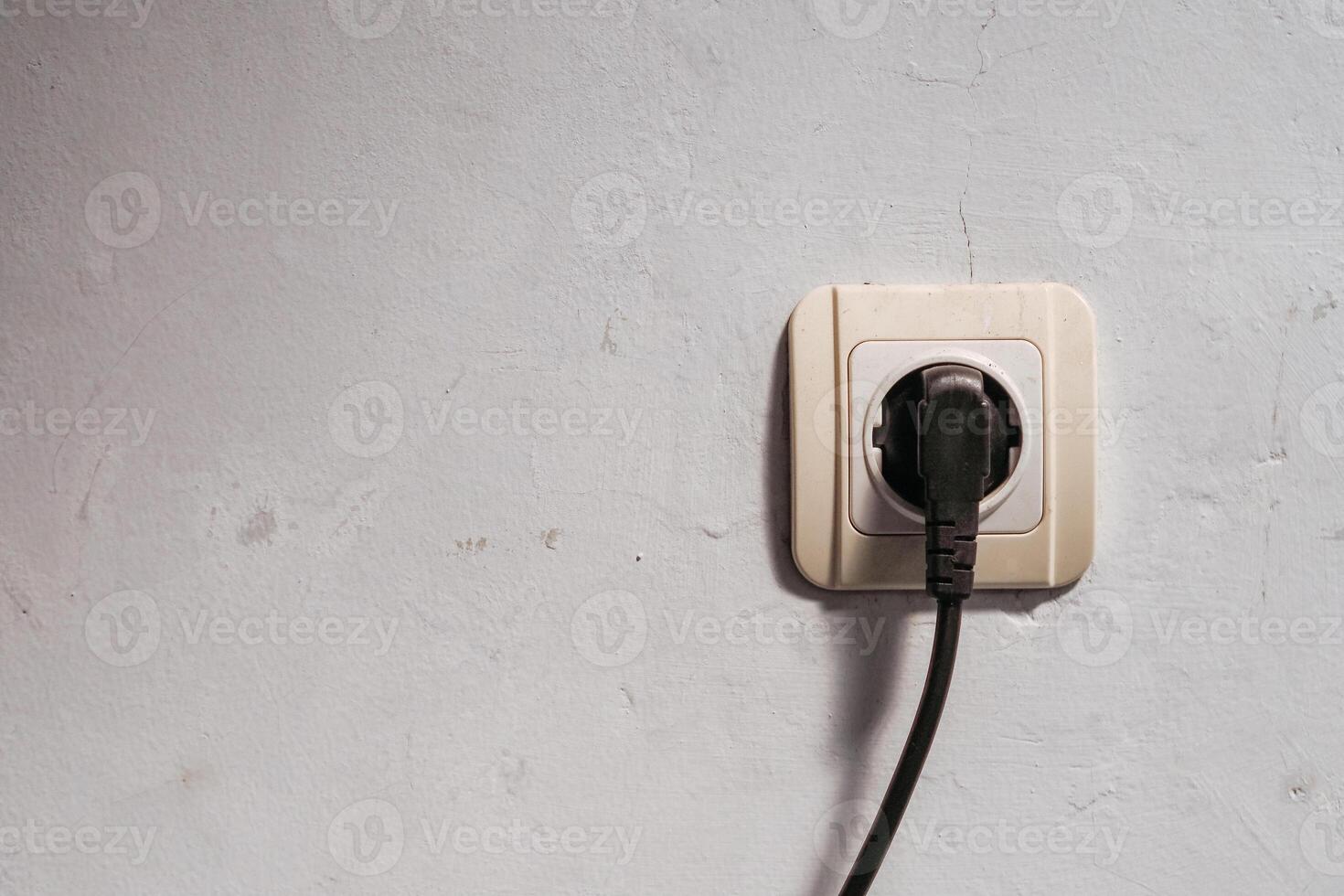 electrical plug in the wall that is being used photo