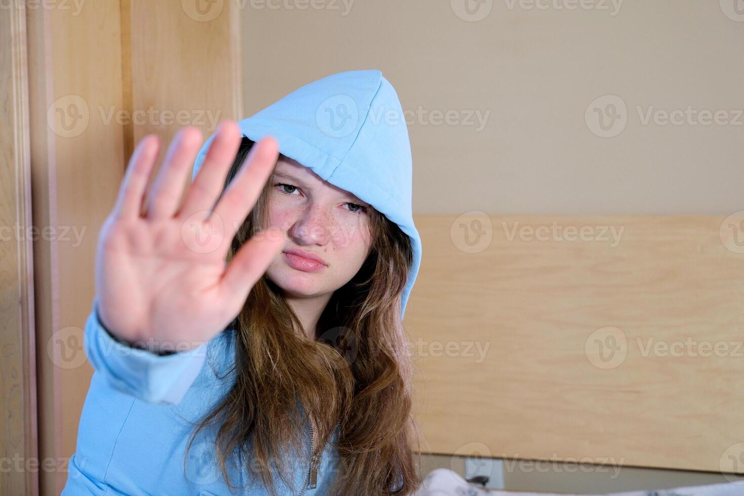 Palm arm raised air angry look straight you will not pass through facial expression harsh. Serious looking strict demands stop, pulls hand forward camera, says no, disagrees, frowns face, warning photo