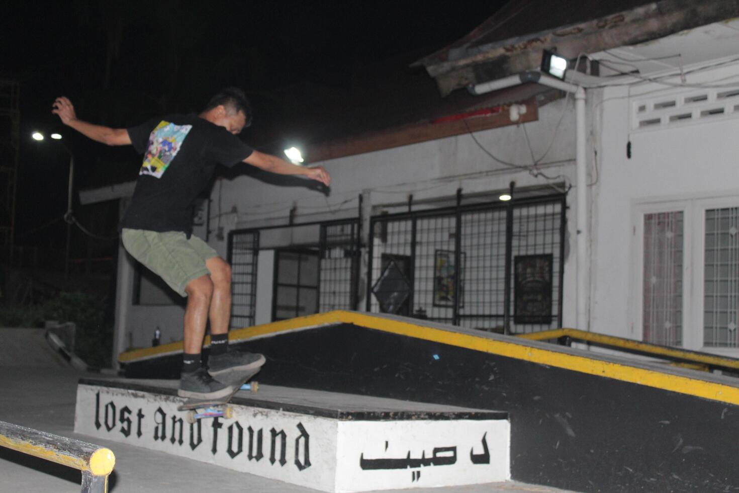 Indonesia - Medan 01 Agustus 2023 an asian man on a skateboard doing tricks on a box photo