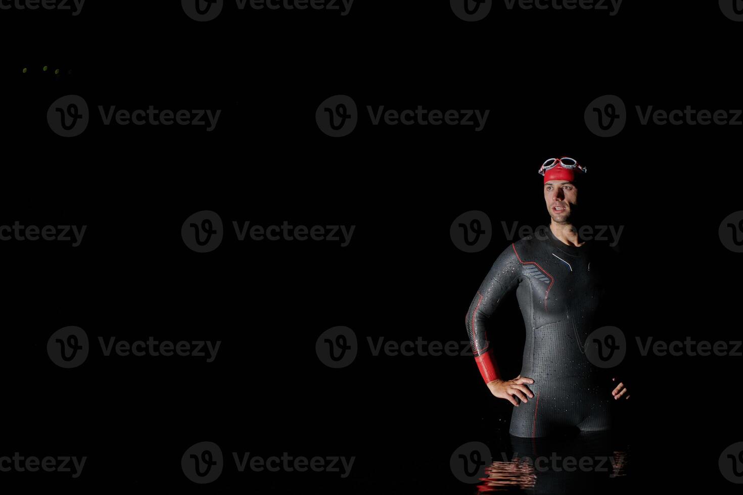 Authentic triathlete swimmer having a break during hard training on night photo