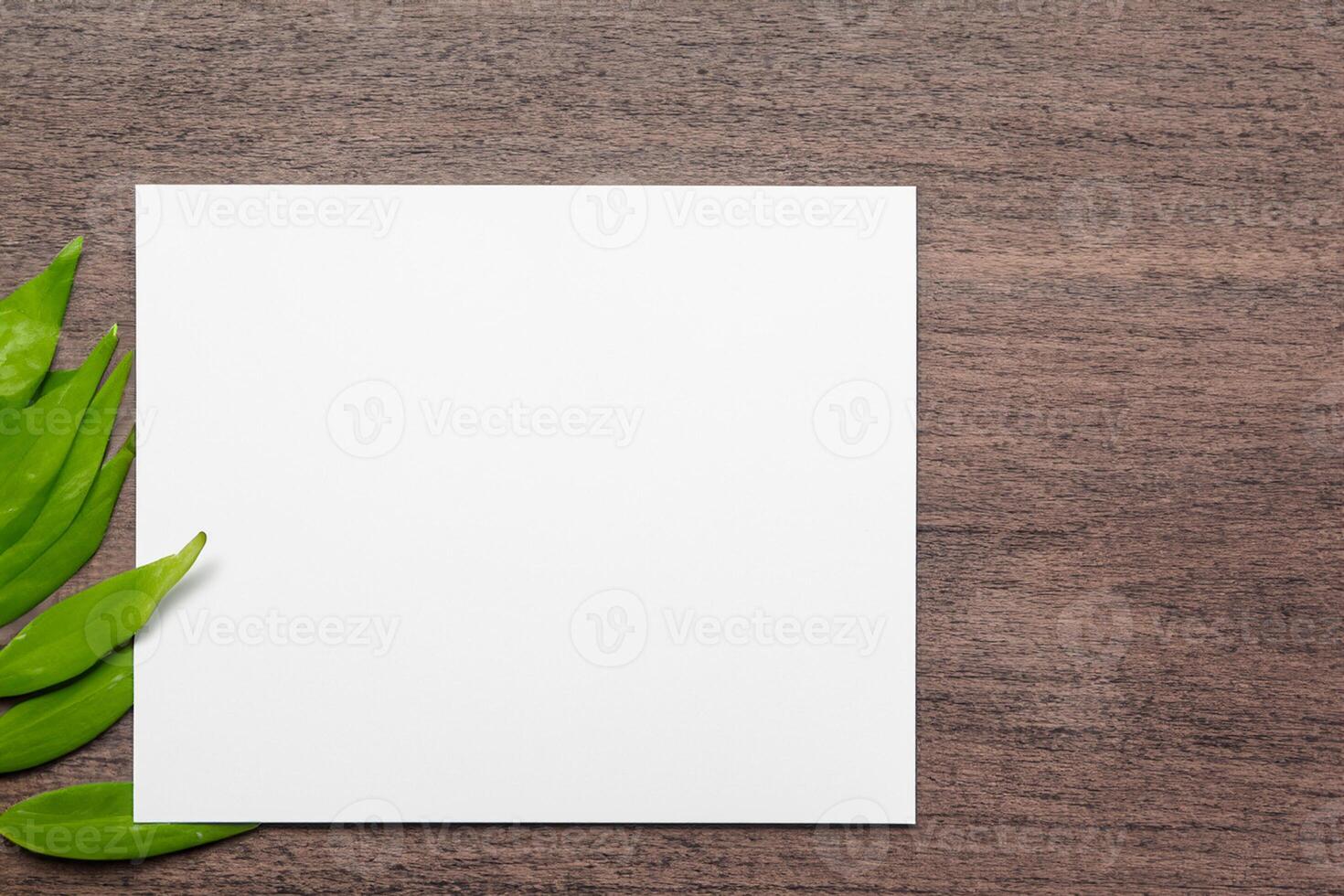 Beautiful Mockup Paper on Wooden Background Combined with Leaves, Creating a Charming and Natural Setting for Creative Designs and Artistic Presentations photo