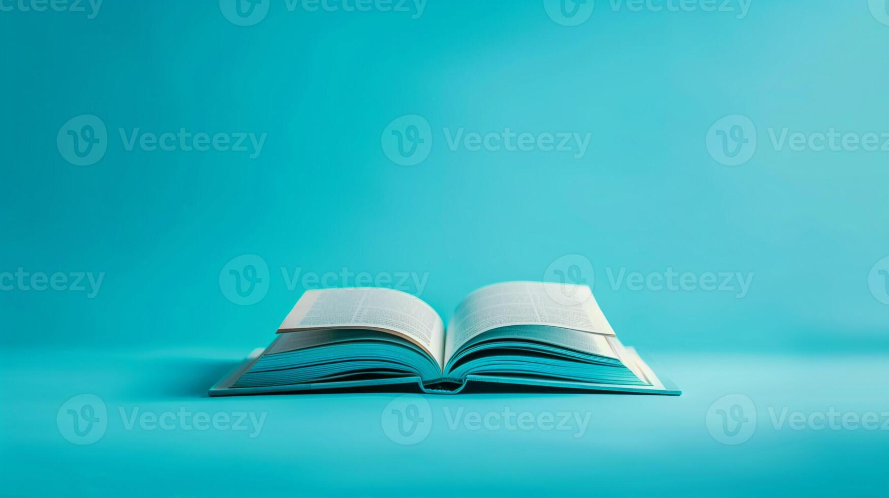 An open hardcover book on a calming teal to indigo gradient background photo
