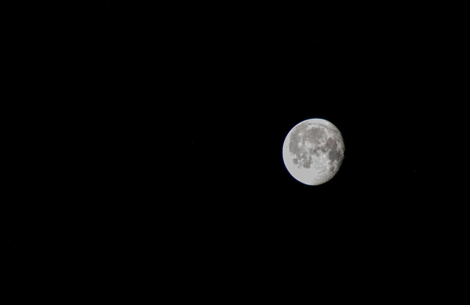 The moon isolated on black background, space for text. photo