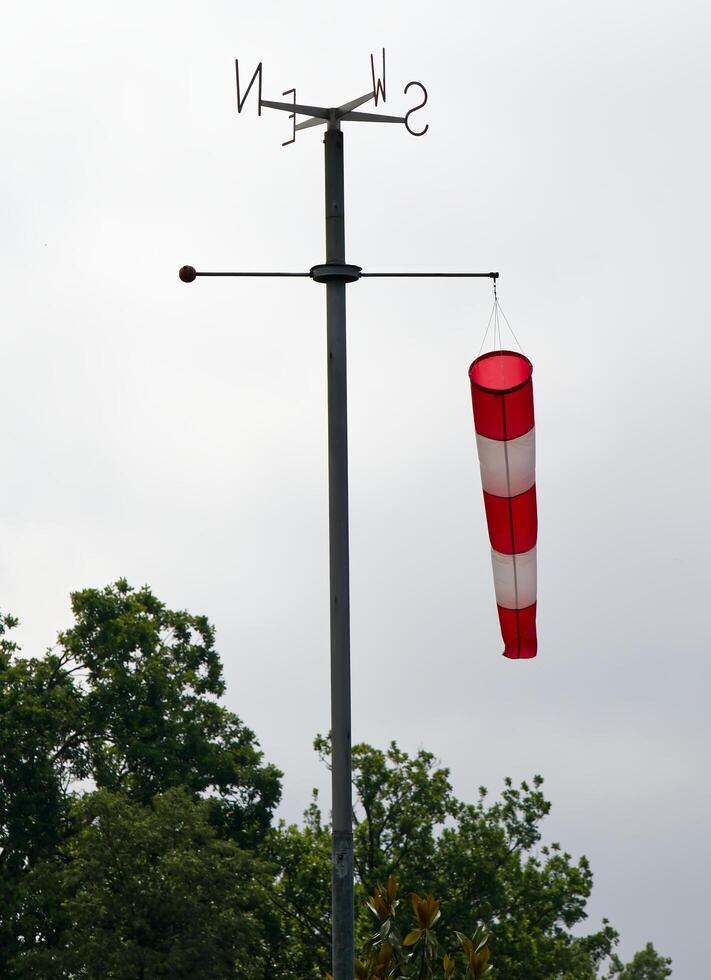 Windsock pointing the wind indicating wind strength and direction. photo