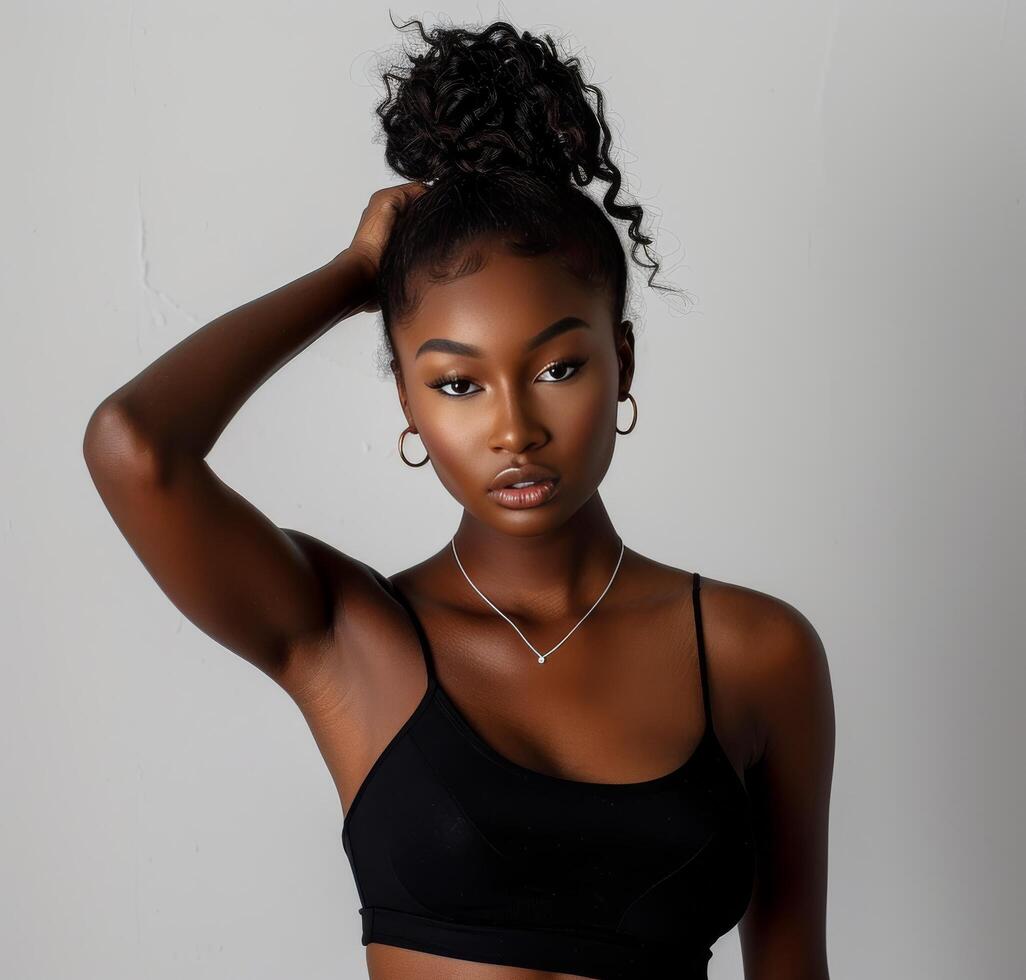 Woman in Black Bodysuit Posing for a Picture photo