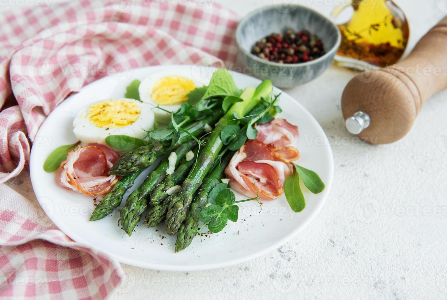 Fresh Asparagus and Prosciutto Salad Served With Boiled Eggs and Microgreens photo