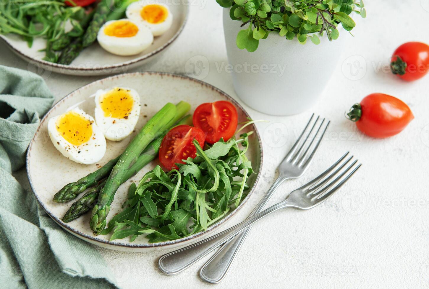 Fresh Spring Salad With Boiled Eggs, Asparagus, and Tomatoes on a Bright Day photo