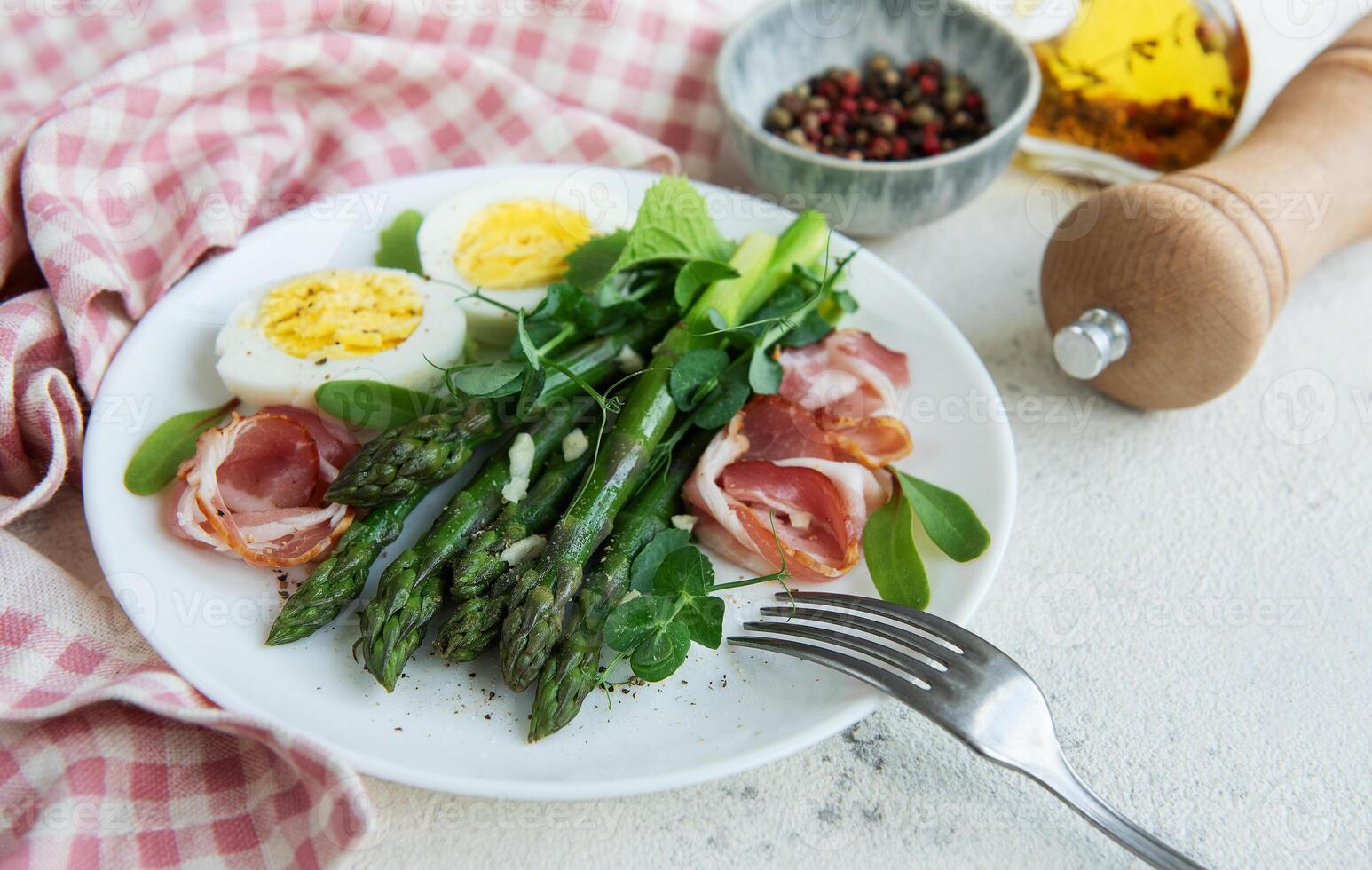 Fresh Asparagus and Prosciutto Salad Served With Boiled Eggs and Microgreens photo