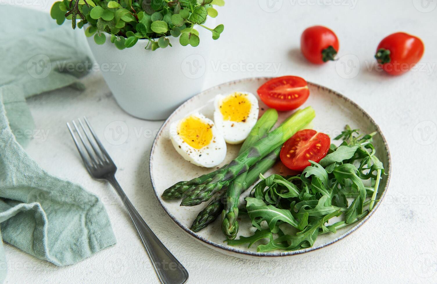 Fresh Spring Salad With Boiled Eggs, Asparagus, and Tomatoes on a Bright Day photo