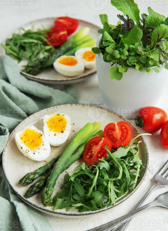 Fresh Spring Salad With Boiled Eggs, Asparagus, and Tomatoes on a Bright Day photo