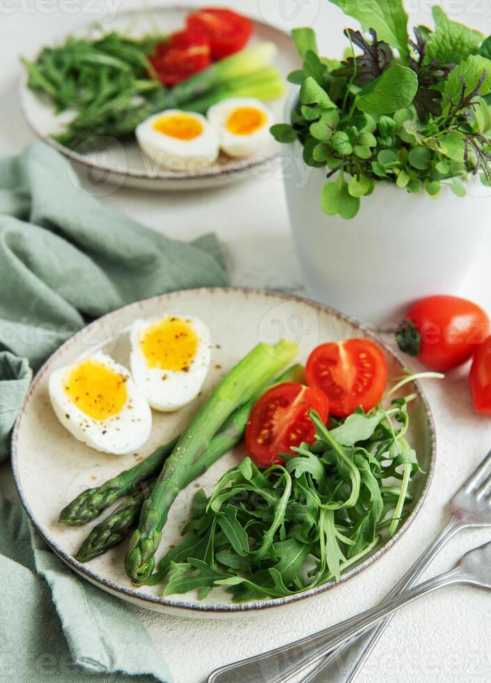 Fresh Spring Salad With Boiled Eggs, Asparagus, and Tomatoes on a Bright Day photo