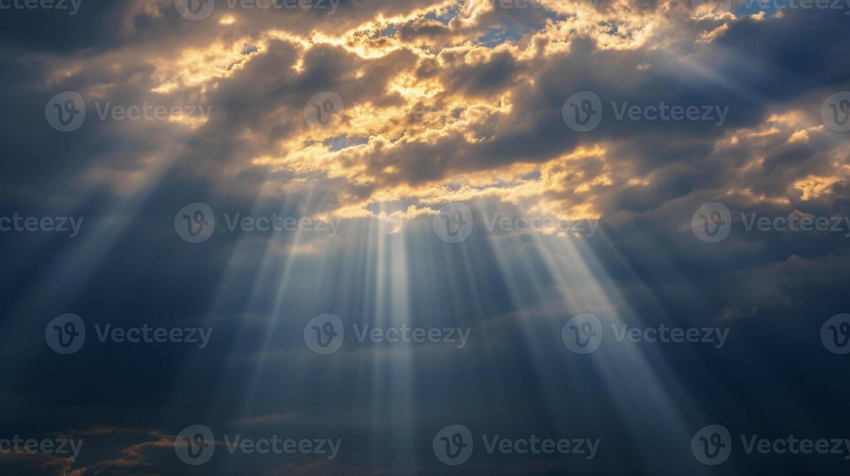 The suns rays shine through a layer of stormy nimbostratus clouds photo