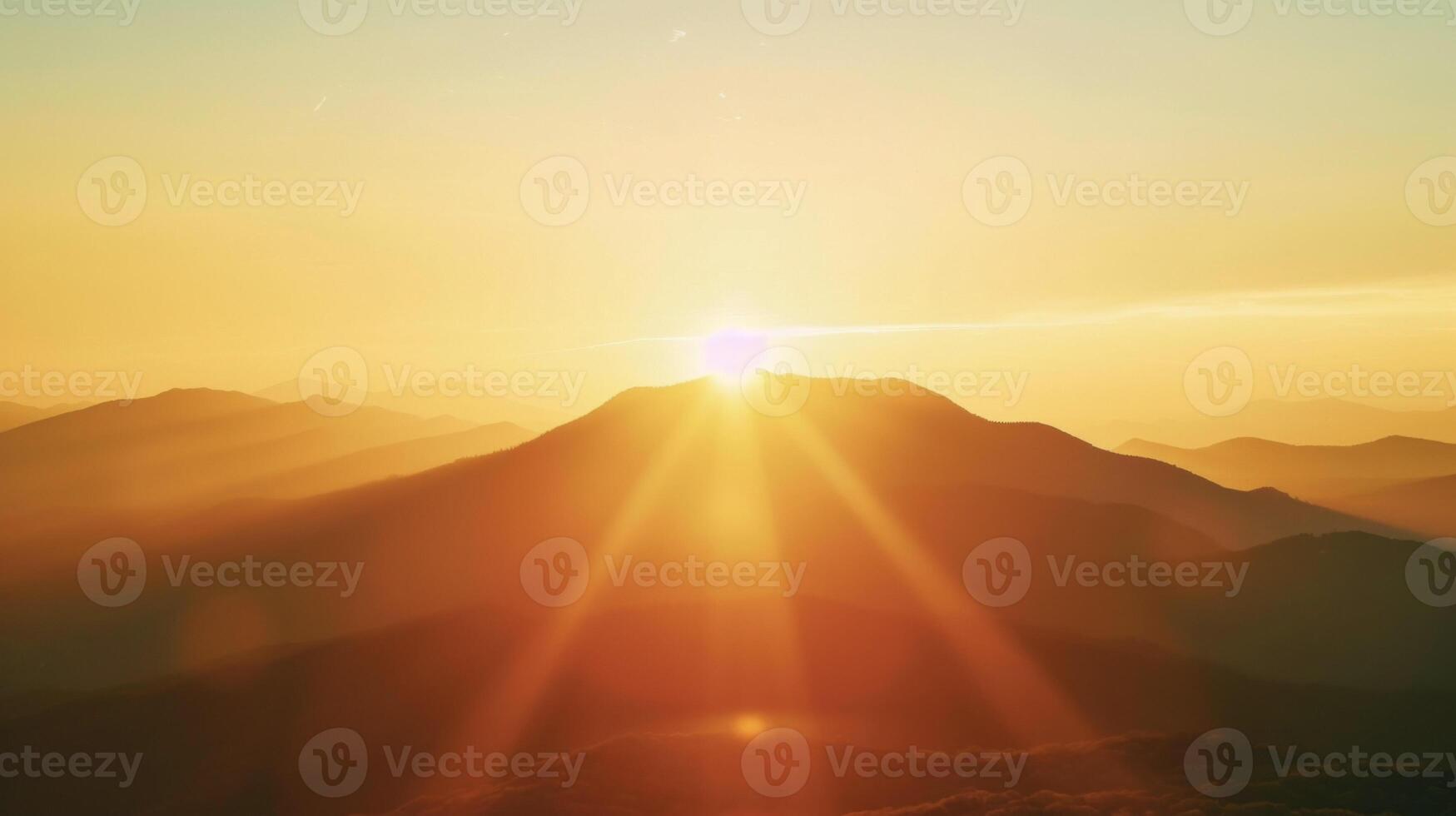 A mountain range in the distance with the sun setting behind it creating a dreamy and ethereal backlight effect photo