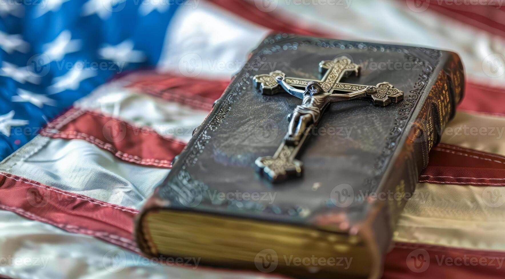 Bbile with a cross lies on top of a red, white and blue American flag photo
