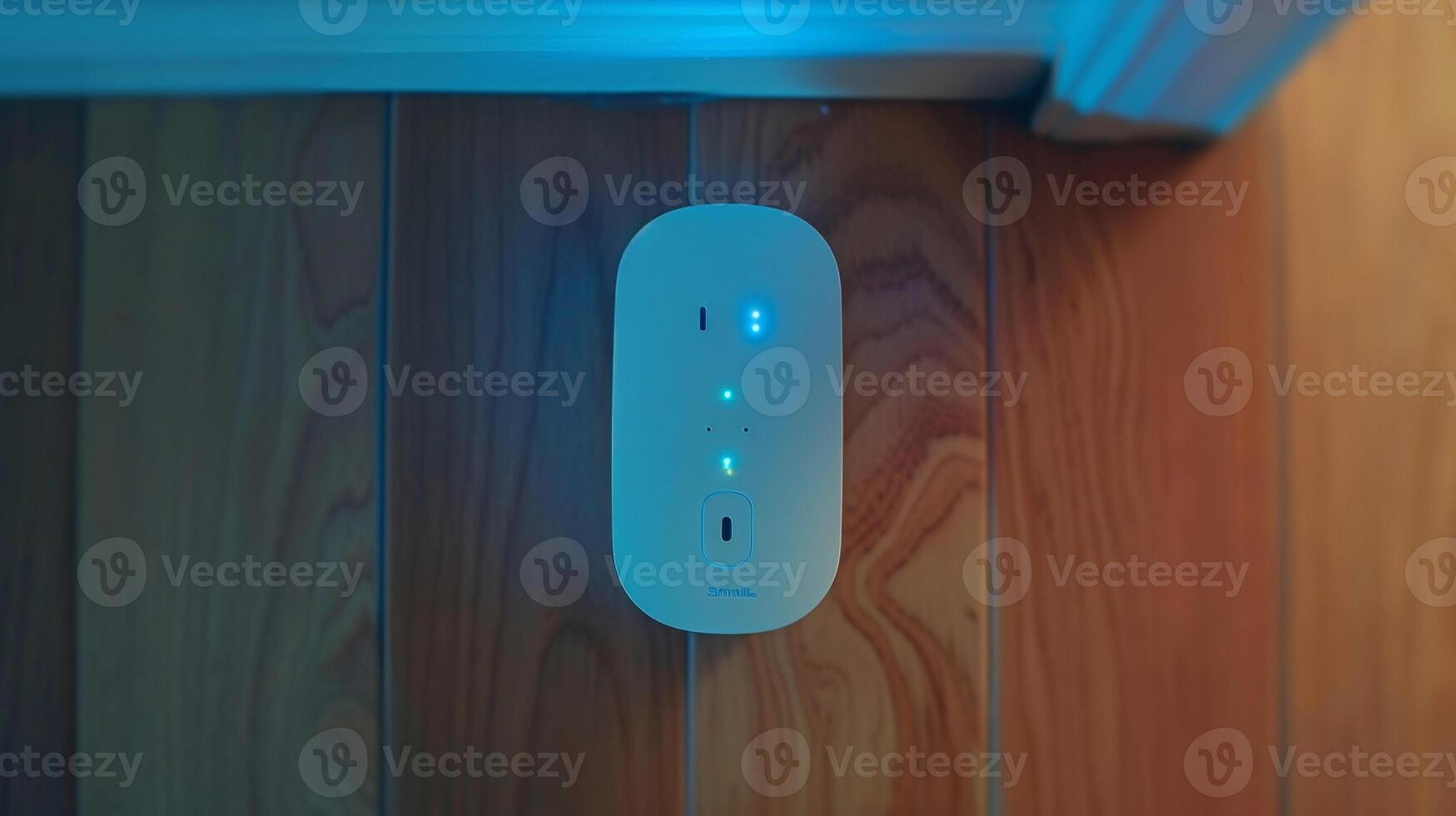 A topdown view of a smart plug with a subtle blue light illuminated indicating that it is connected to a WiFi network and ready to be controlled remotely photo