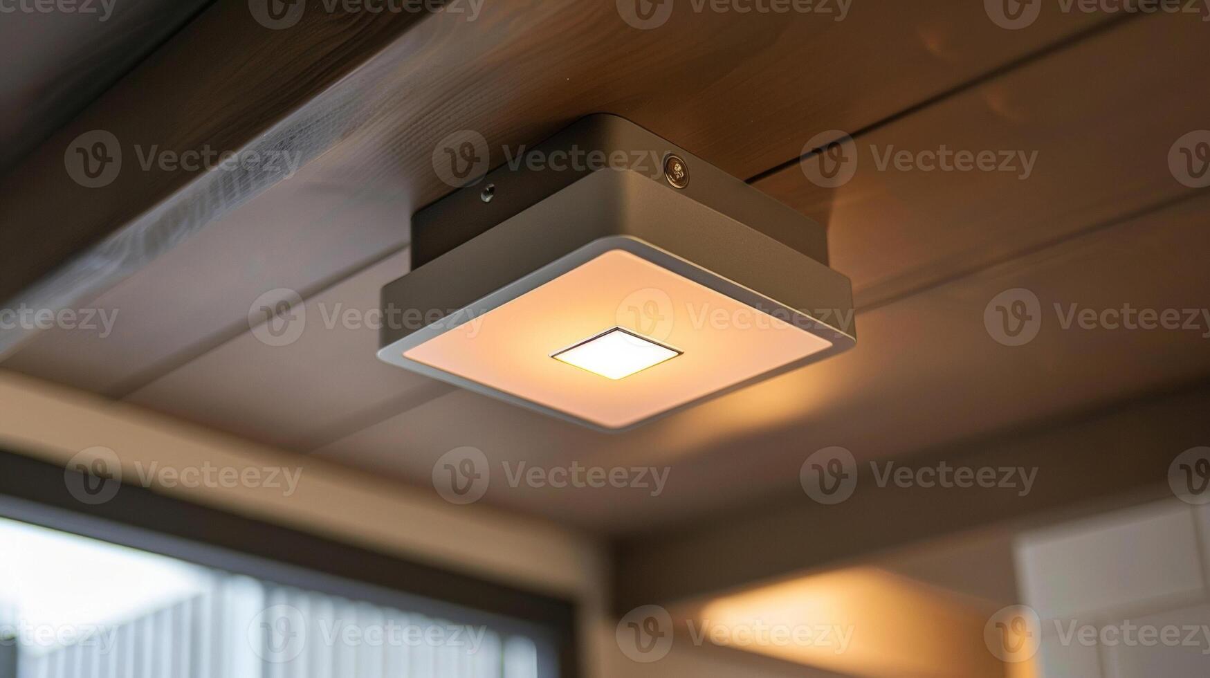 An industrialstyle motion sensor light with a metal body and a large square sensor in the center photo