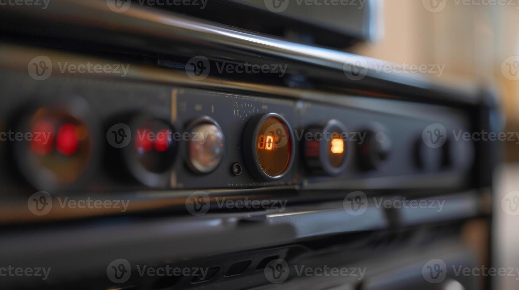 A closeup of the temperature control on the top of the oil heater labeled with numbers ranging from 110 photo