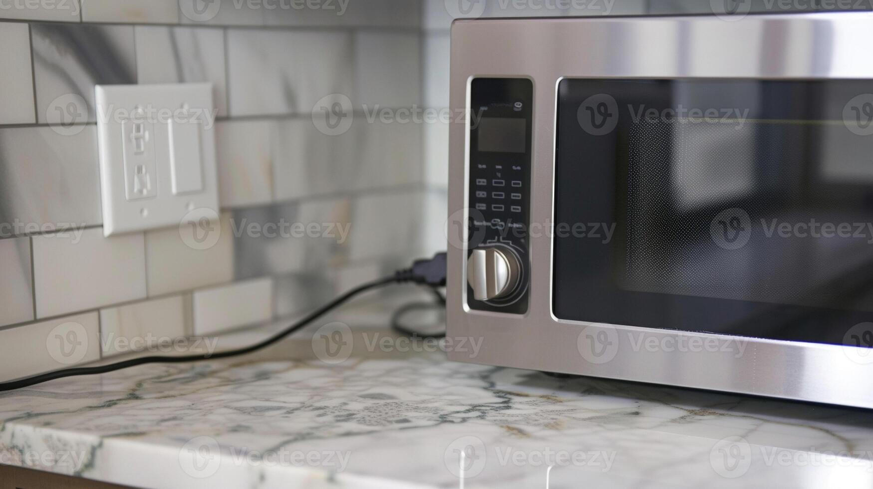 Detailed image of the microwaves power cord plugged into a nearby outlet photo