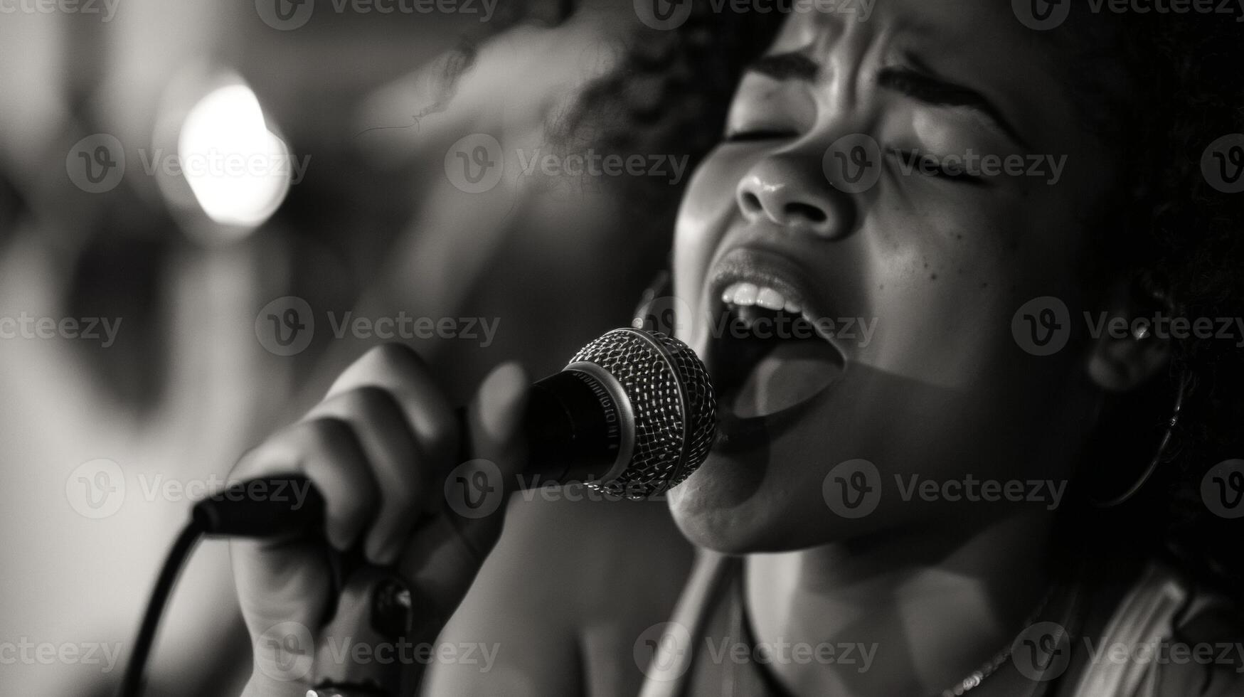 A young singer with a soulful voice takes the microphone belting out heartfelt lyrics that resonate with the audience. Her passion is evident in her every movement and expression photo
