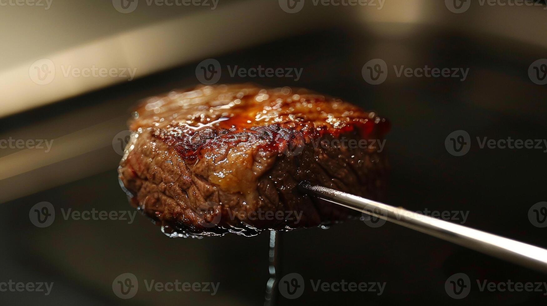 The temperature probe delicately inserted into the center of a perfectly cooked piece of meat photo