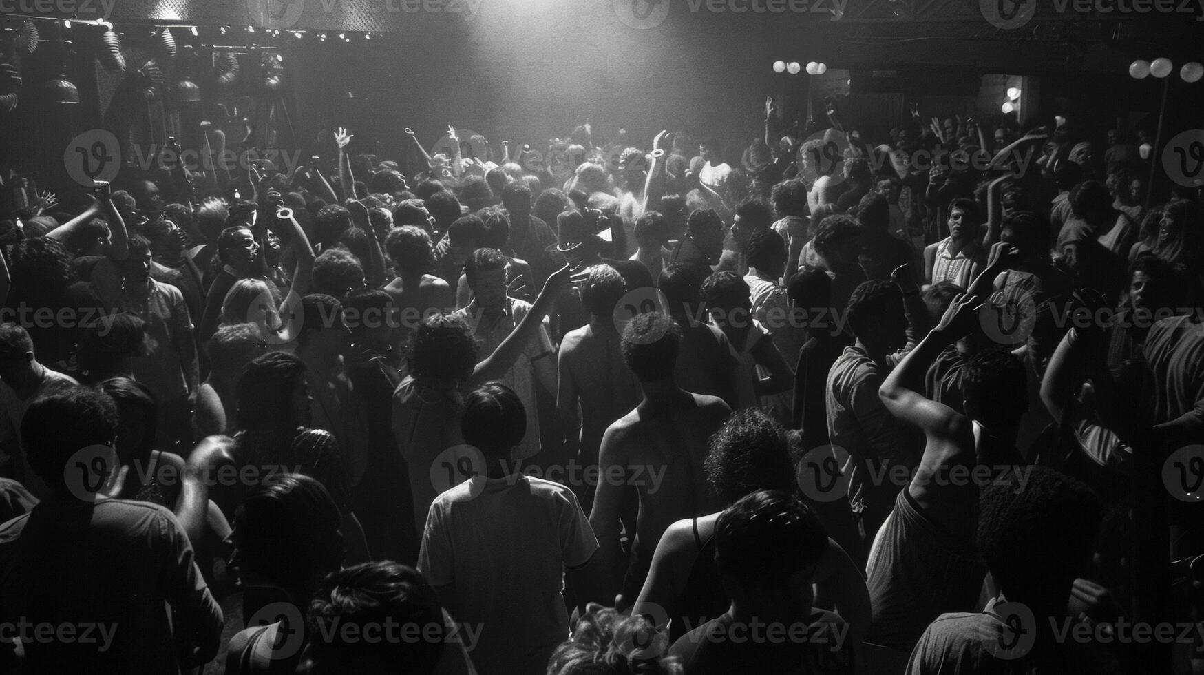 The loud bass and t drums reverberate through the packed nightclub as enthusiastic music fans lose themselves in the moment their movements freeing and uninhibited photo